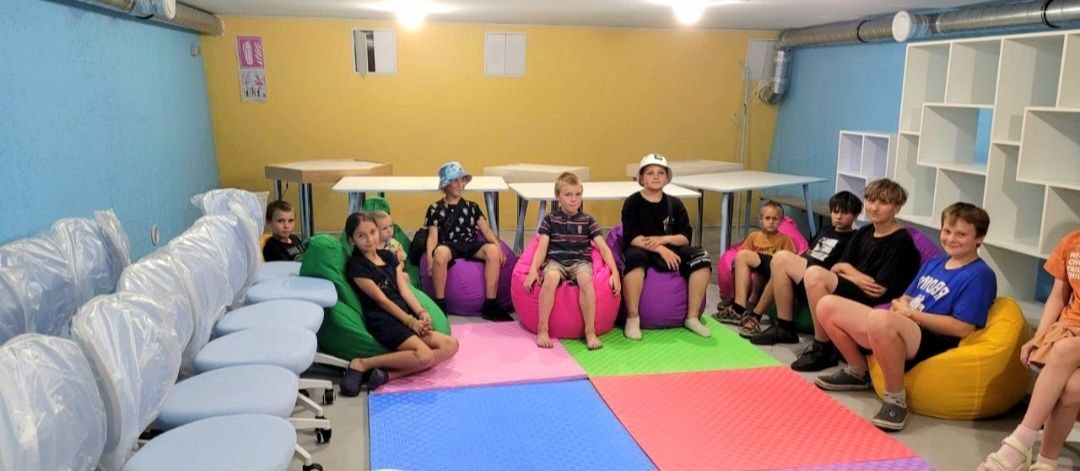 Students seated on new bean bag chairs in the finished bunker classroom at Vyvodove Gymnasium, August 2026.