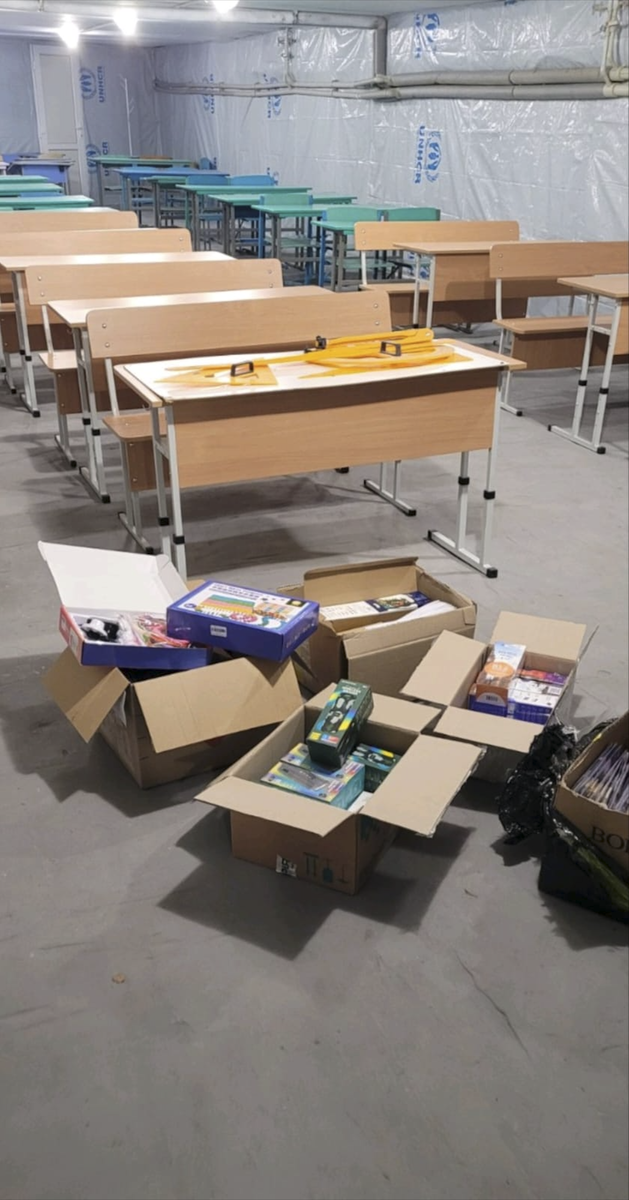 New desks and teaching supplies arriving at the underground classroom.