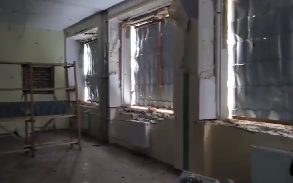 A damaged classroom missing basic materials.